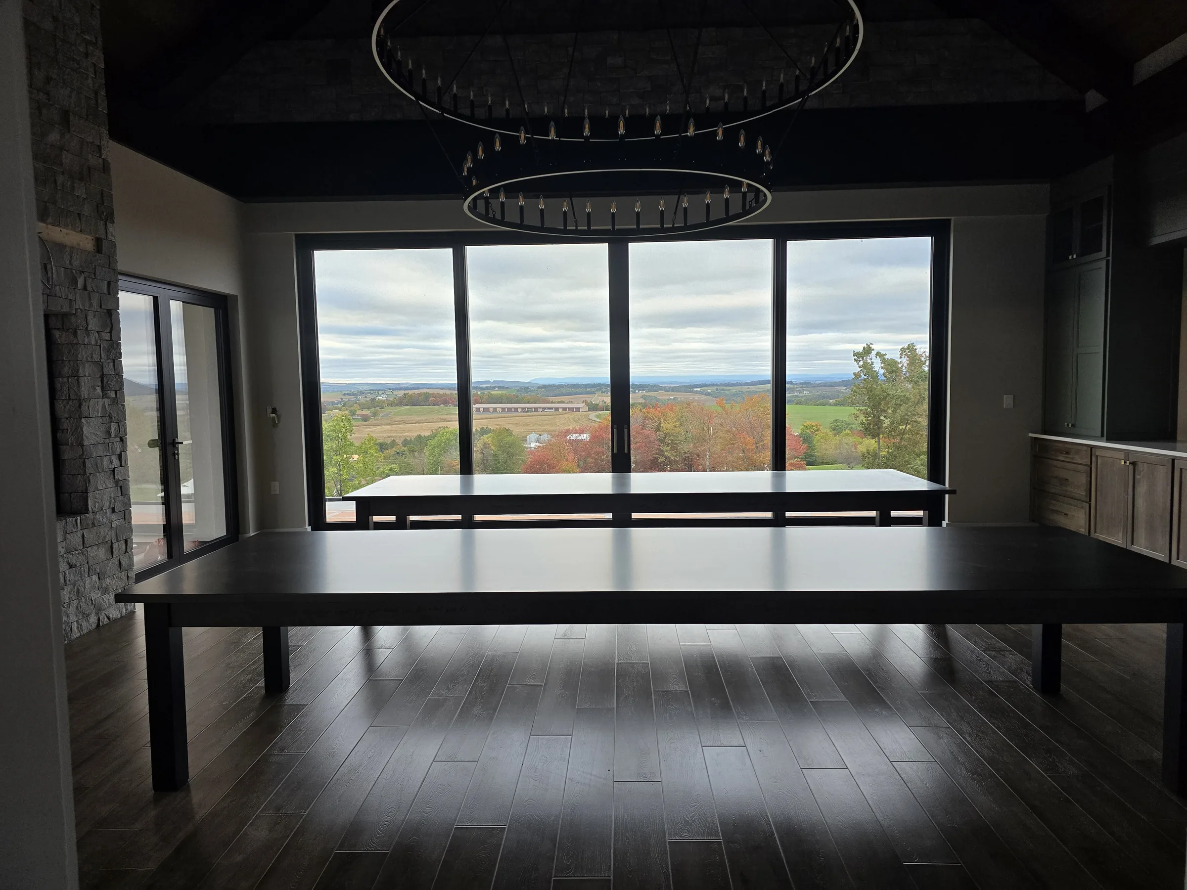 Dining room of the Modern Mountain House opening to a panoramic mountain view