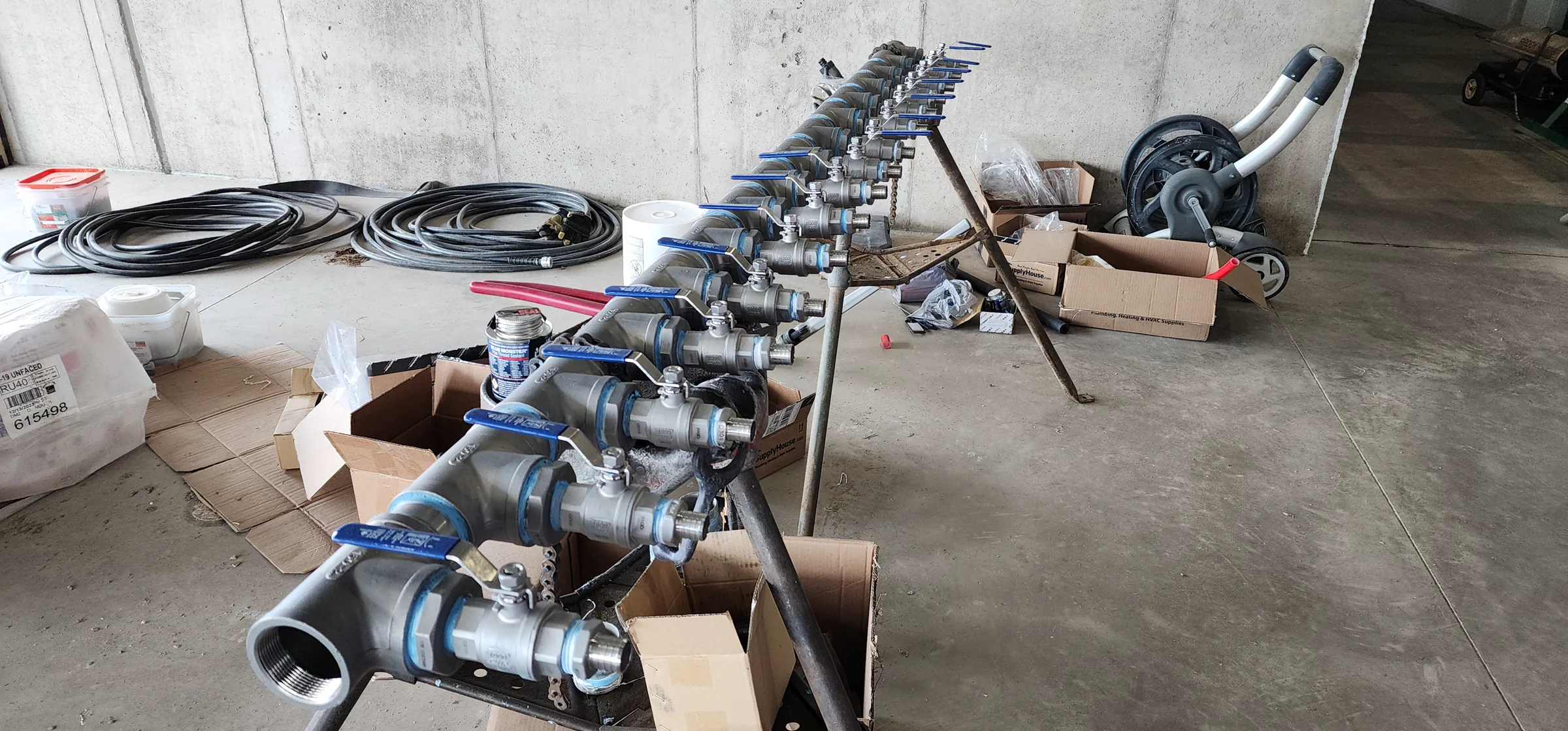 Mechanical piping manifold with a row of isolation valves being assembled at the Modern Mountain House