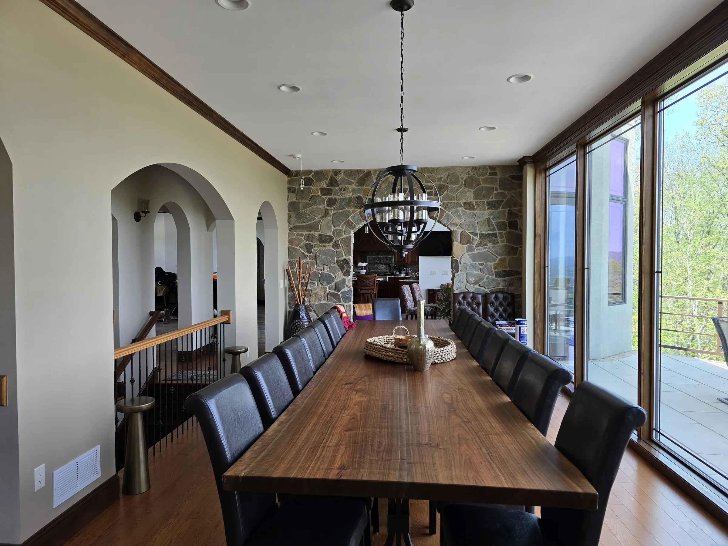 Dining room with a long table, stone arches, and views toward the Pennsylvania landscape
