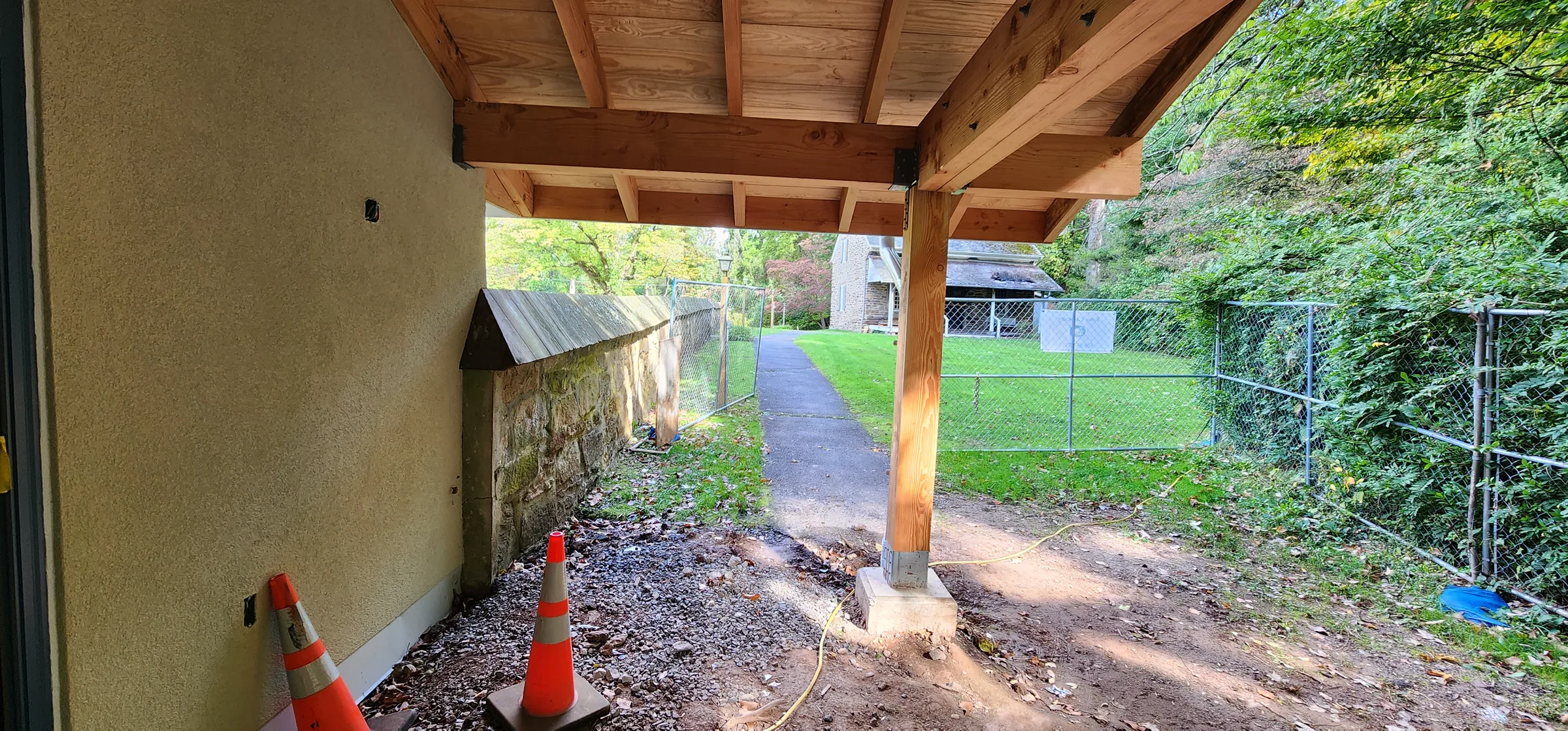 Covered walkway and entrance at Friends First School nearing completion with new stucco and timber framing