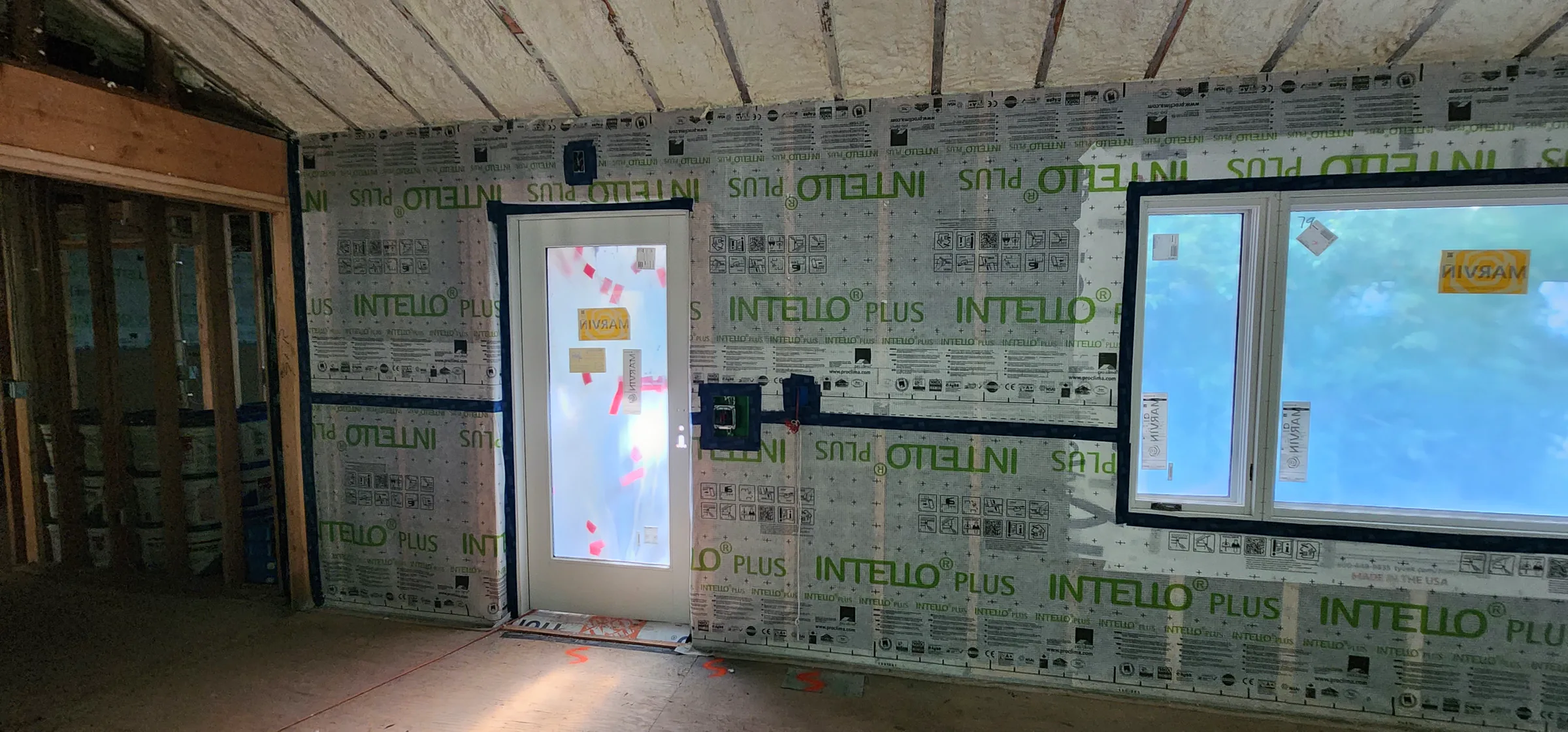 Friends First School interior during construction with Intello membrane installed across the renewed wall assembly