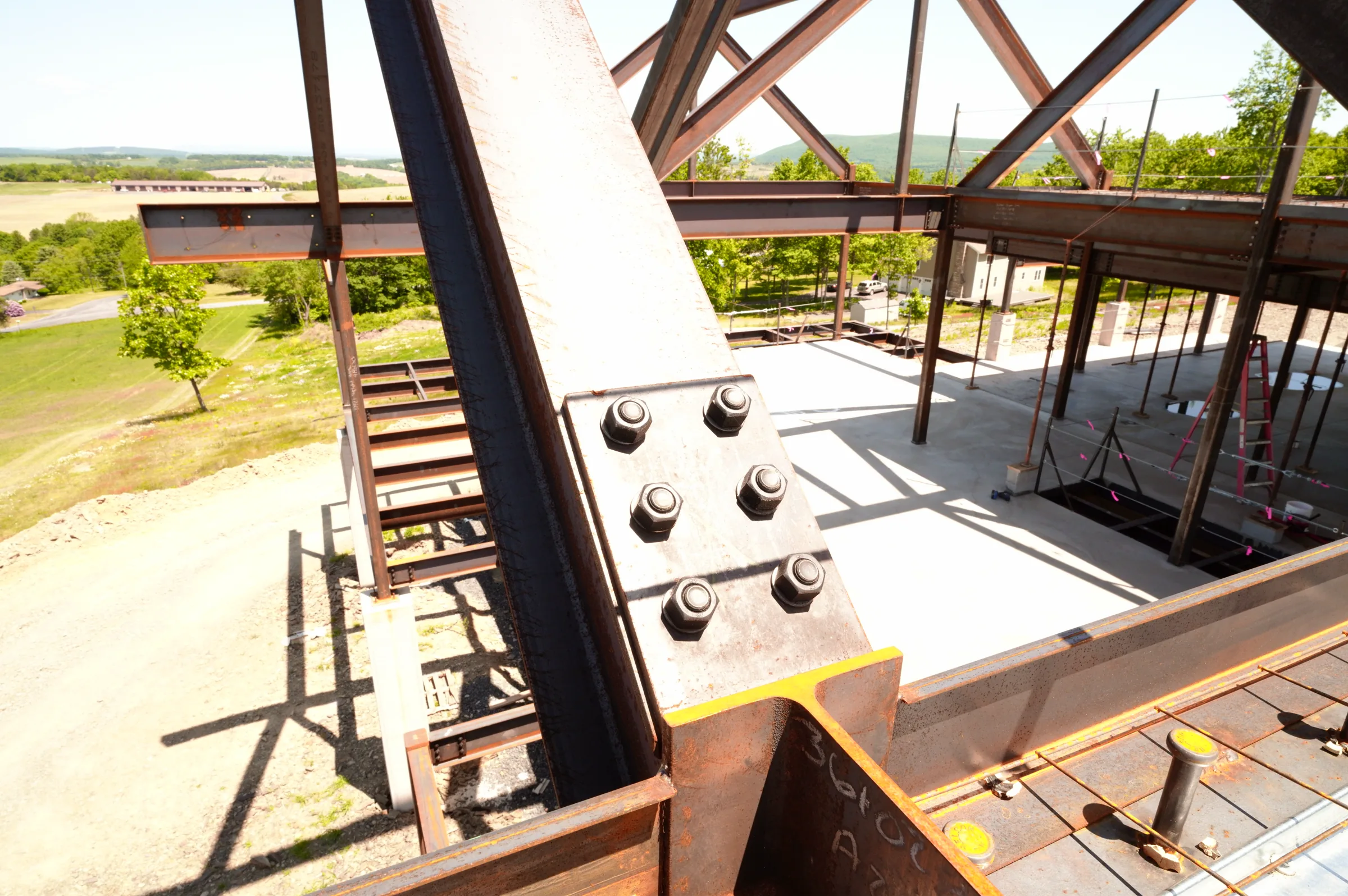 Close view of bolted structural-steel connections within a house under construction