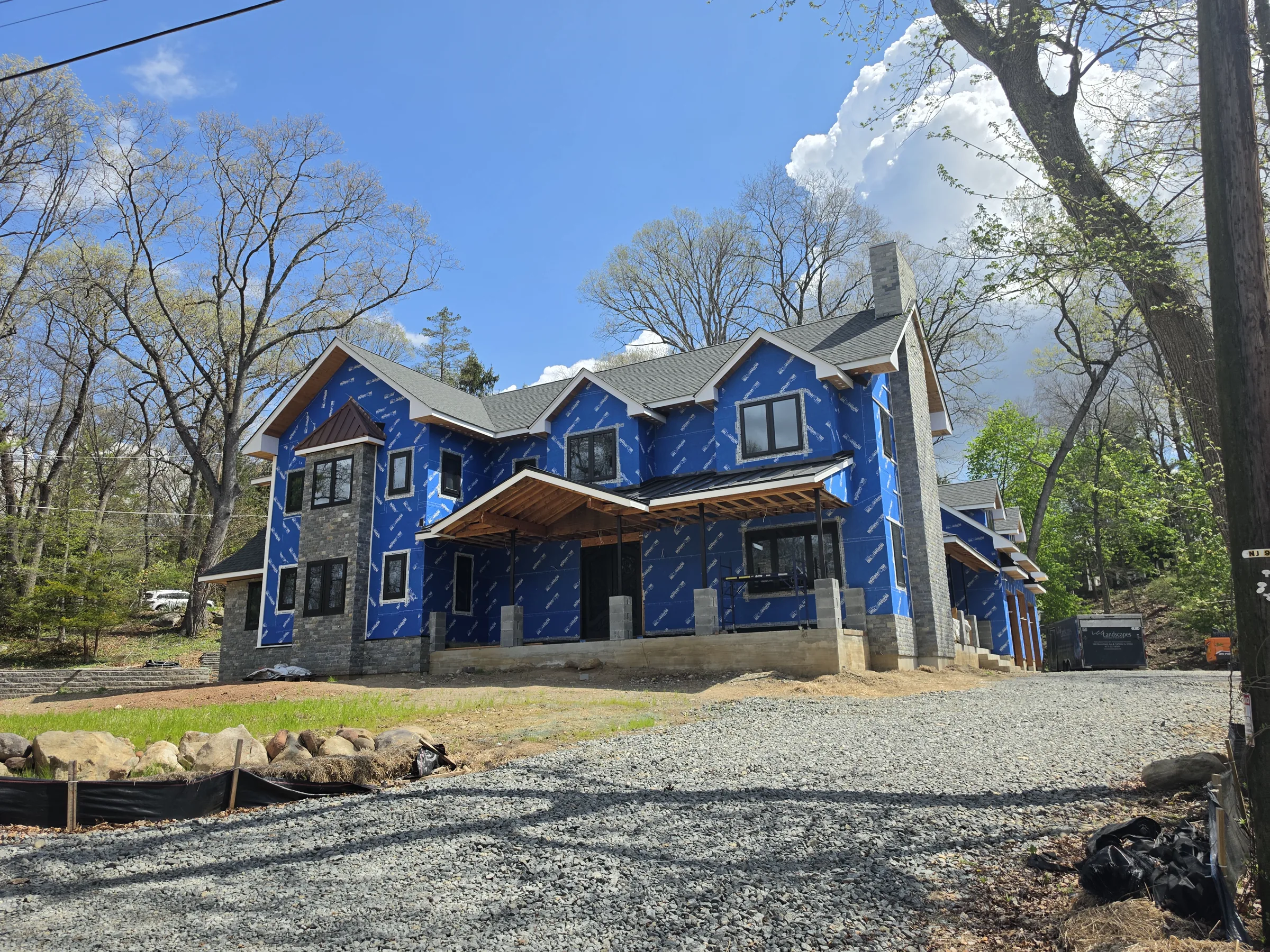 Closer low-angle construction view of the new residence and its framed front elevation